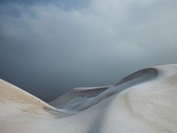 Sand dunes against sky