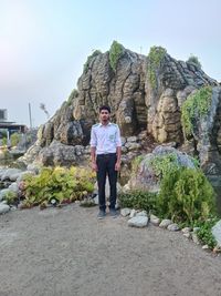 Rear view of man standing on rock