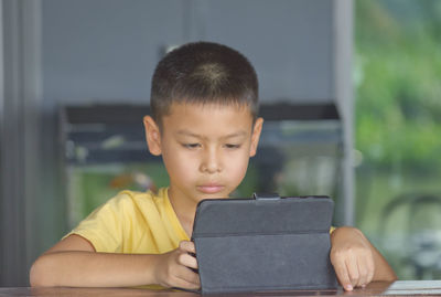 Portrait of boy sitting on mobile phone