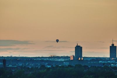 Buildings in city at sunset
