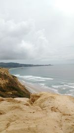 Scenic view of sea against cloudy sky