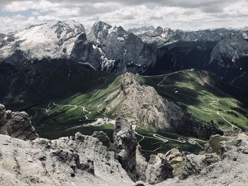 Aerial view of land and mountains against sky