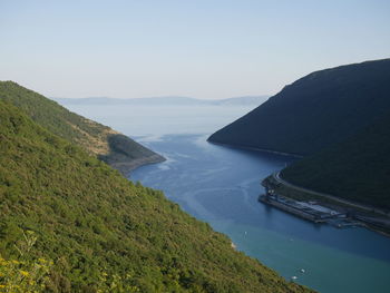 High angle view of sea and mountains against sky