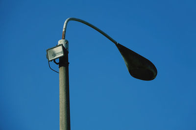 Low angle view of street light against clear blue sky