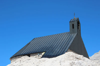 Low angle view of building against clear blue sky