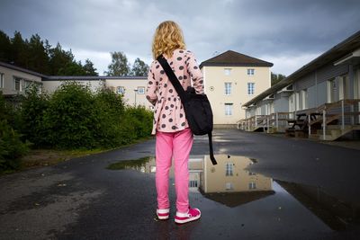 Rear view of woman standing against sky