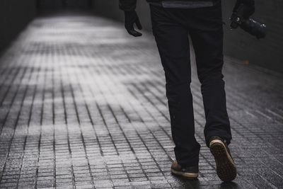 Low section of man standing on footpath