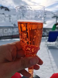 Close-up of hand holding beer glass