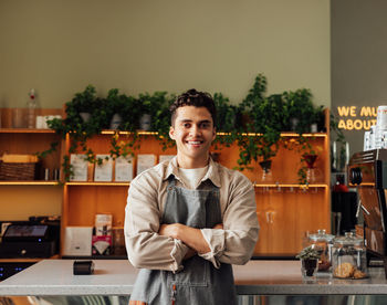 Portrait of smiling young man standing at home