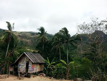 House on field against cloudy sky