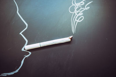 High angle view of cigarette on table