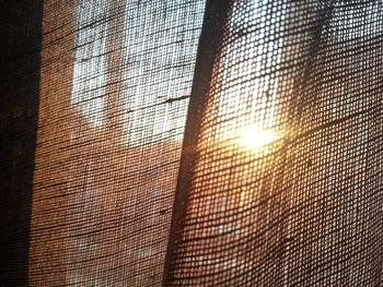 Full frame shot of sun shining through curtain