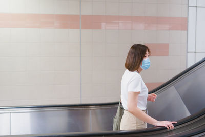 Solo asian woman wearing protective mask during transport to work or travel