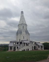 Church by building against sky