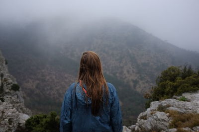 High angle rear view of woman contemplating the mountains