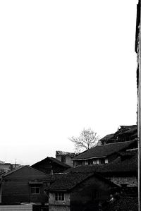 Low angle view of houses against clear sky