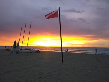 Scenic view of beach against sky during sunset