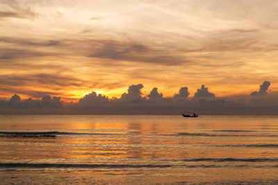 Scenic view of sea against orange sky