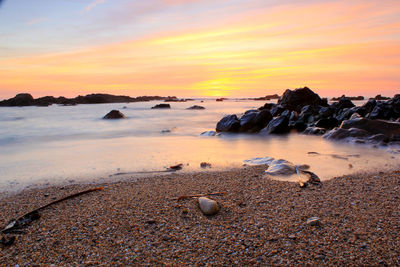 Scenic view of beach against sky during sunset