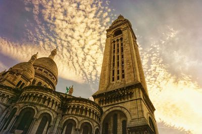 Low angle view of cathedral against cloudy sky