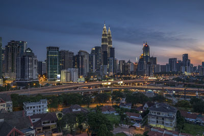 View of skyscrapers in city against cloudy sky