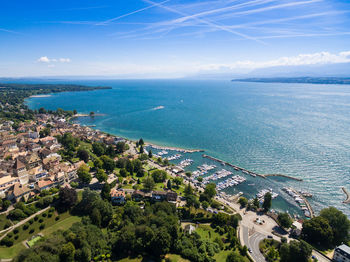 High angle view of townscape by sea against sky