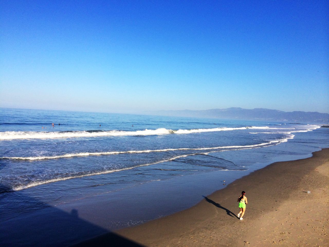 sea, beach, clear sky, copy space, water, blue, leisure activity, shore, lifestyles, scenics, sand, tranquility, vacations, tranquil scene, beauty in nature, nature, horizon over water, men