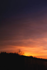 Silhouette landscape against sky during sunset