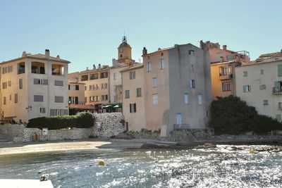 Buildings in city against clear sky