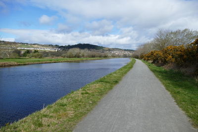 Empty road along countryside landscape