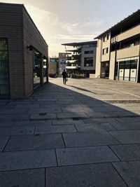 Man walking on street amidst buildings in city