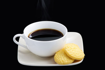 Close-up of coffee cup against black background