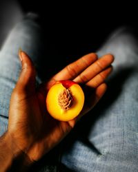 Midsection of man holding apricot