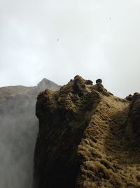 Rock formations on mountain against sky