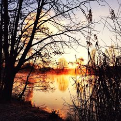 Scenic view of lake at sunset