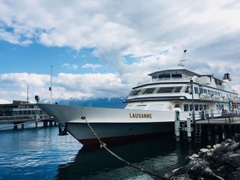 Ship moored at harbor against sky