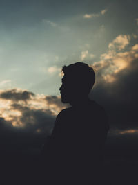 Silhouette man standing against sky during sunset