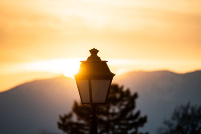 Low angle view of street lamp during sunset