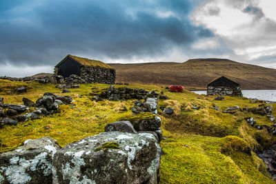 An old abandoned hamlet in the faroe islands. mountains and lake on background. high quality photo