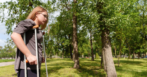 Side view of young woman standing in park