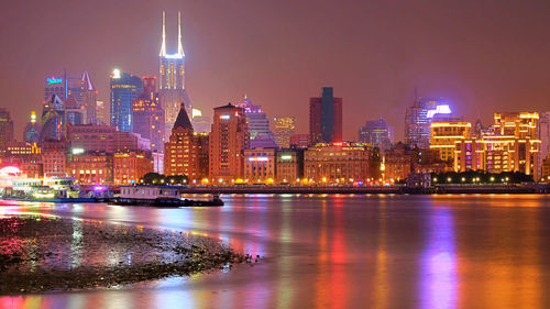 Illuminated buildings in city at night