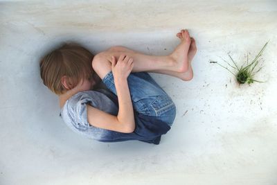 High angle view of boy sleeping on floor