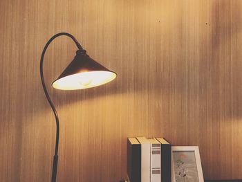 Close-up of illuminated lamp on table