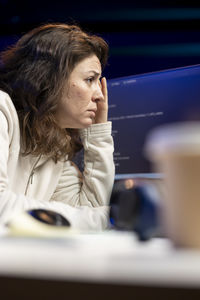 Young woman using mobile phone at restaurant