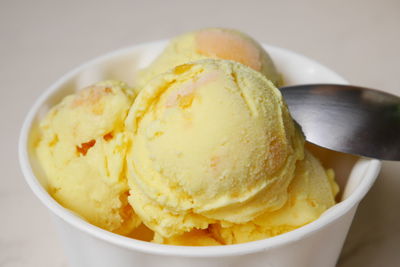 Close-up of yellow ice cream in bowl