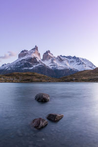 Scenic view of sea and snowcapped mountains against sky