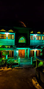 Illuminated building against sky at night