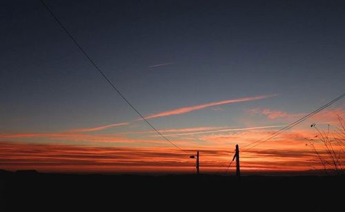 Low angle view of silhouette landscape against sky