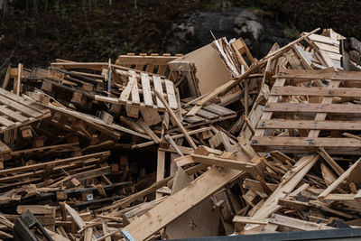 Pile of old and broken wooden pallets