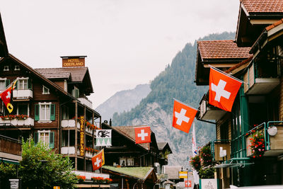 Houses and buildings against sky in city